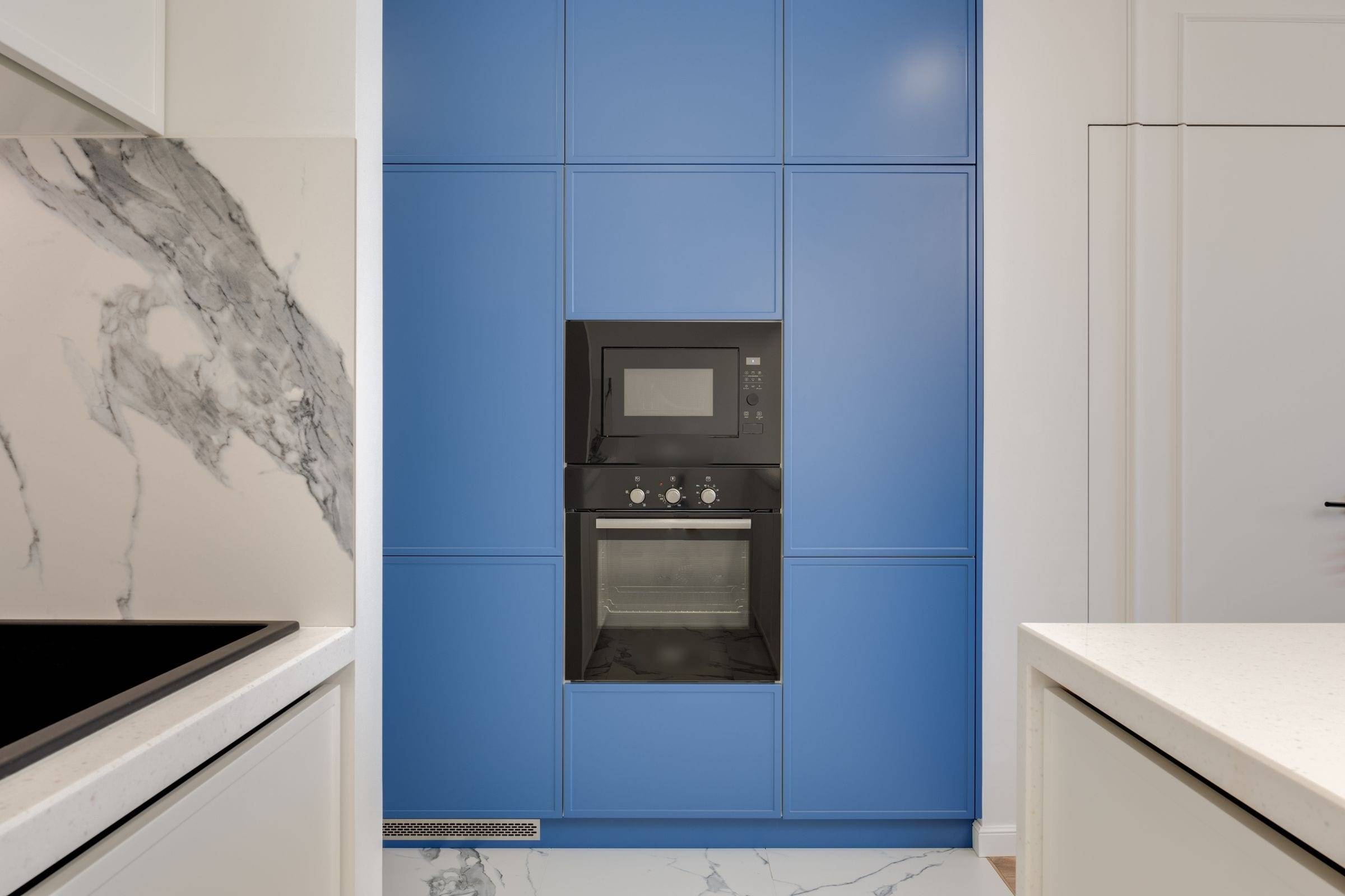 Colonne bleue mate avec un four et un micro-ondes encastrés à hauteur